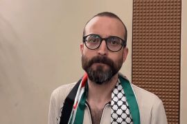 Freed prisoner and novelist Basem Khandakji wears a Palestinian scarf.